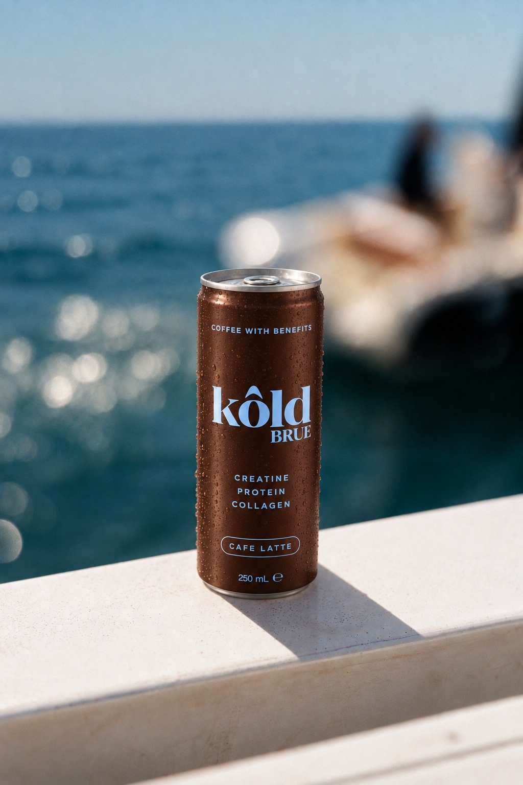 A KôldBrue can on a ledge by the ocean